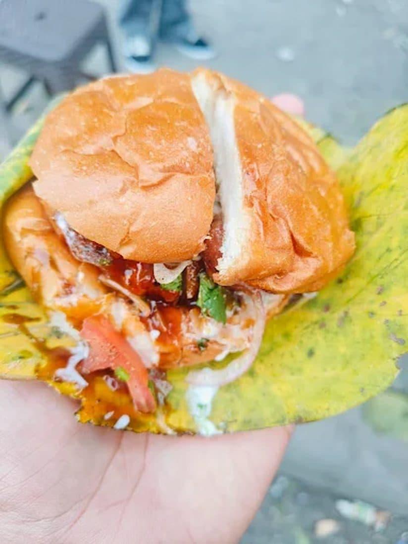A Dehradun bun-tikki — soft bun stuffed with potato tikki, chutney, onion and tomato, served on a leaf