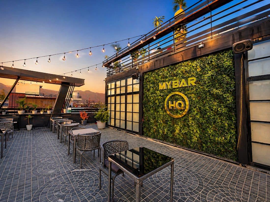 The rooftop of My Bar Headquarters in Dehradun at dusk with string lights