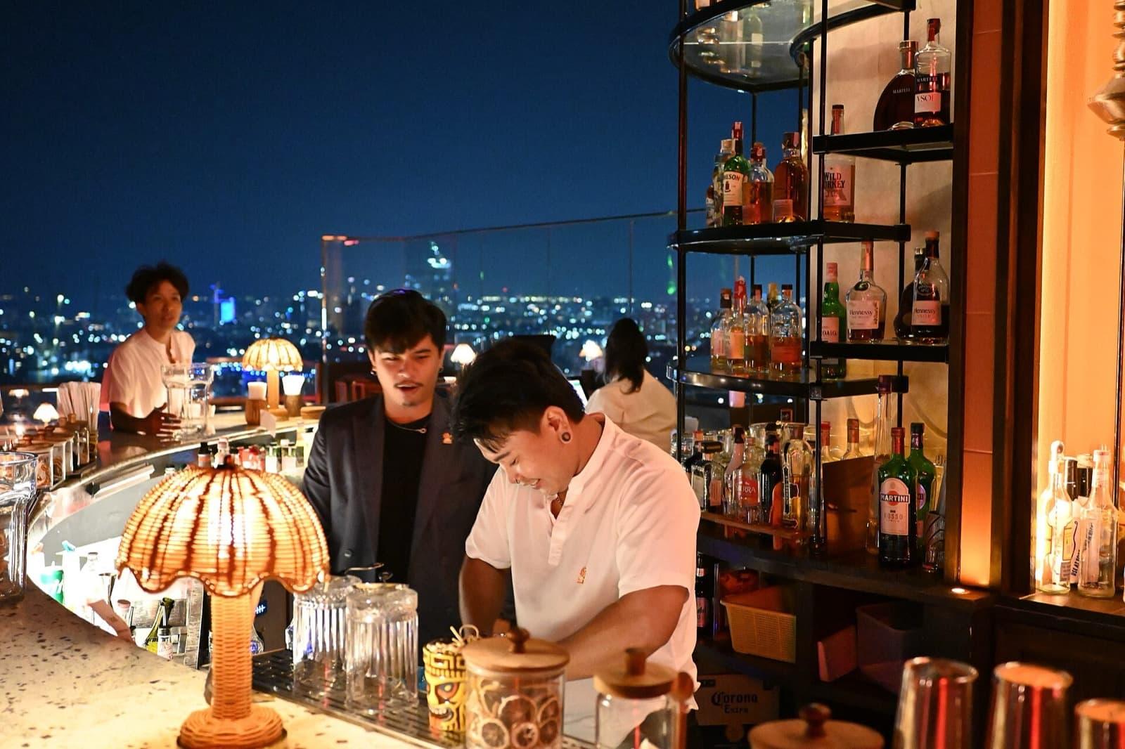 A rooftop bar lit up in the evening