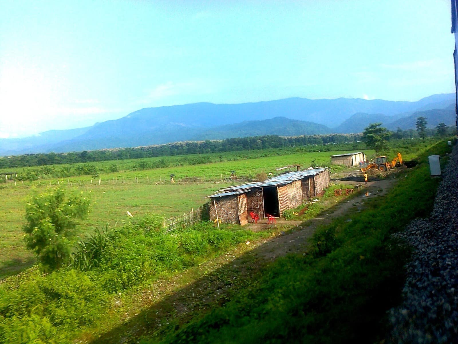 View of the green Himalayan foothills from a train window approaching Dehradun