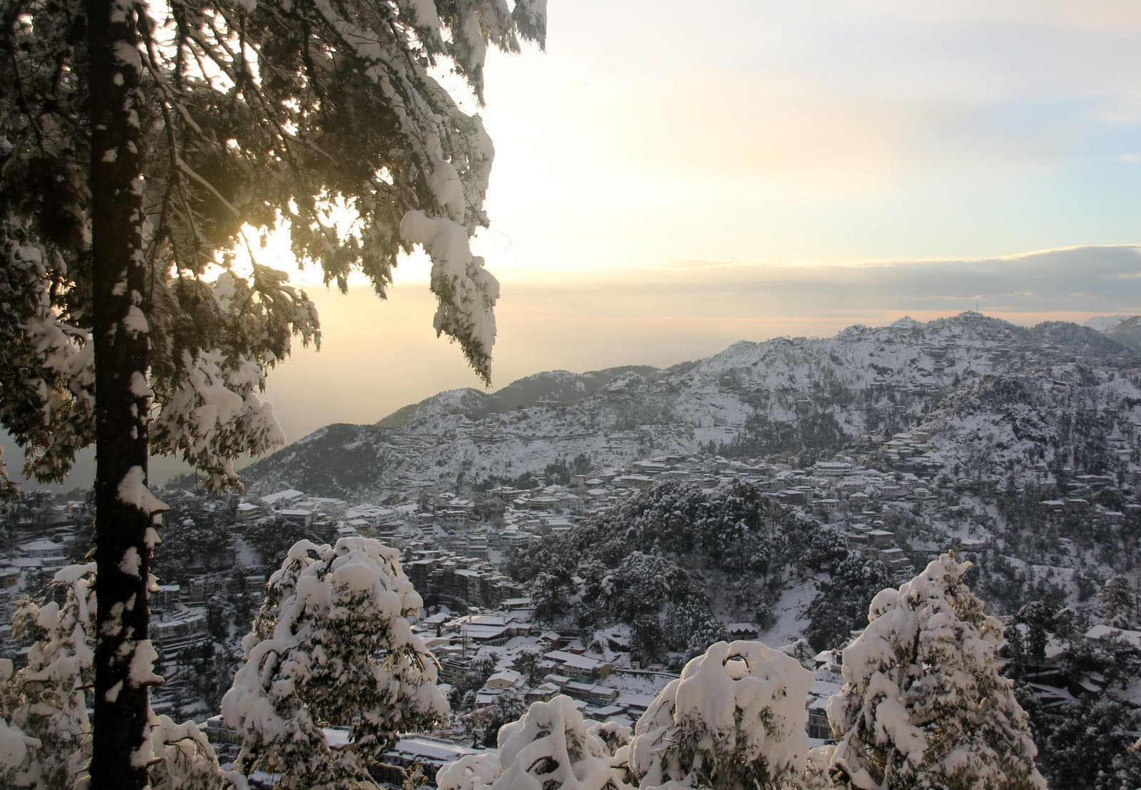 The snow-covered Mussoorie ridge above the Doon valley on a clear January morning