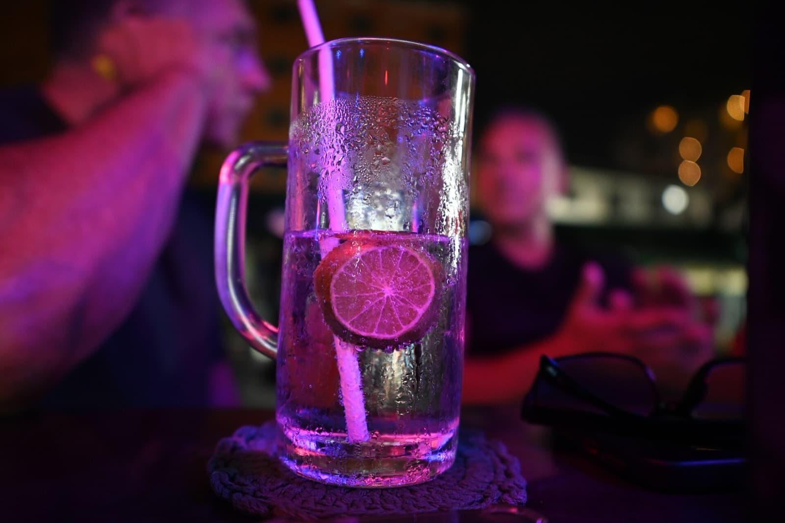A neon-lit cocktail at a Dehradun bar at night