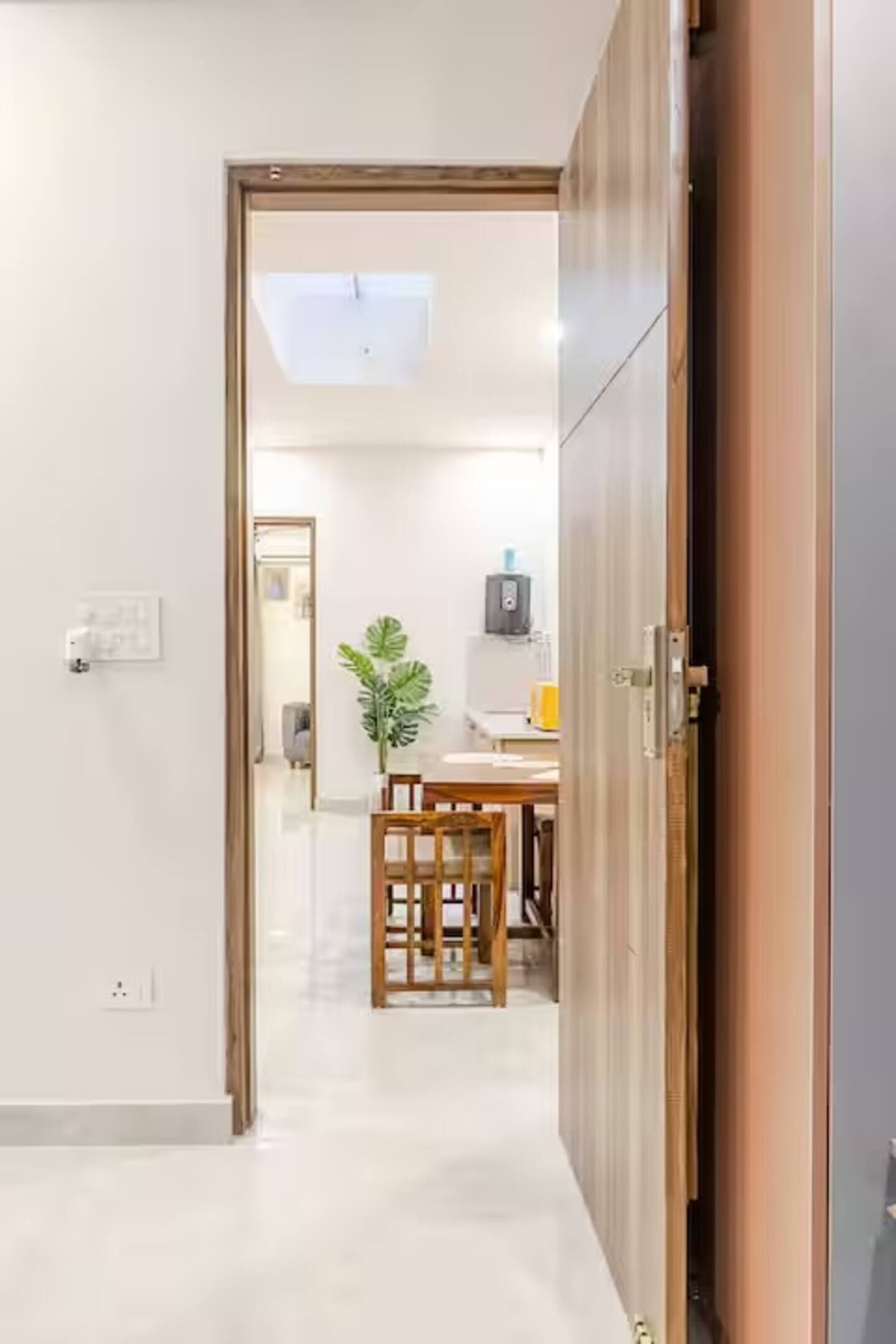 Boho by Starfish: Doorway view into the kitchen and dining area with a wooden table