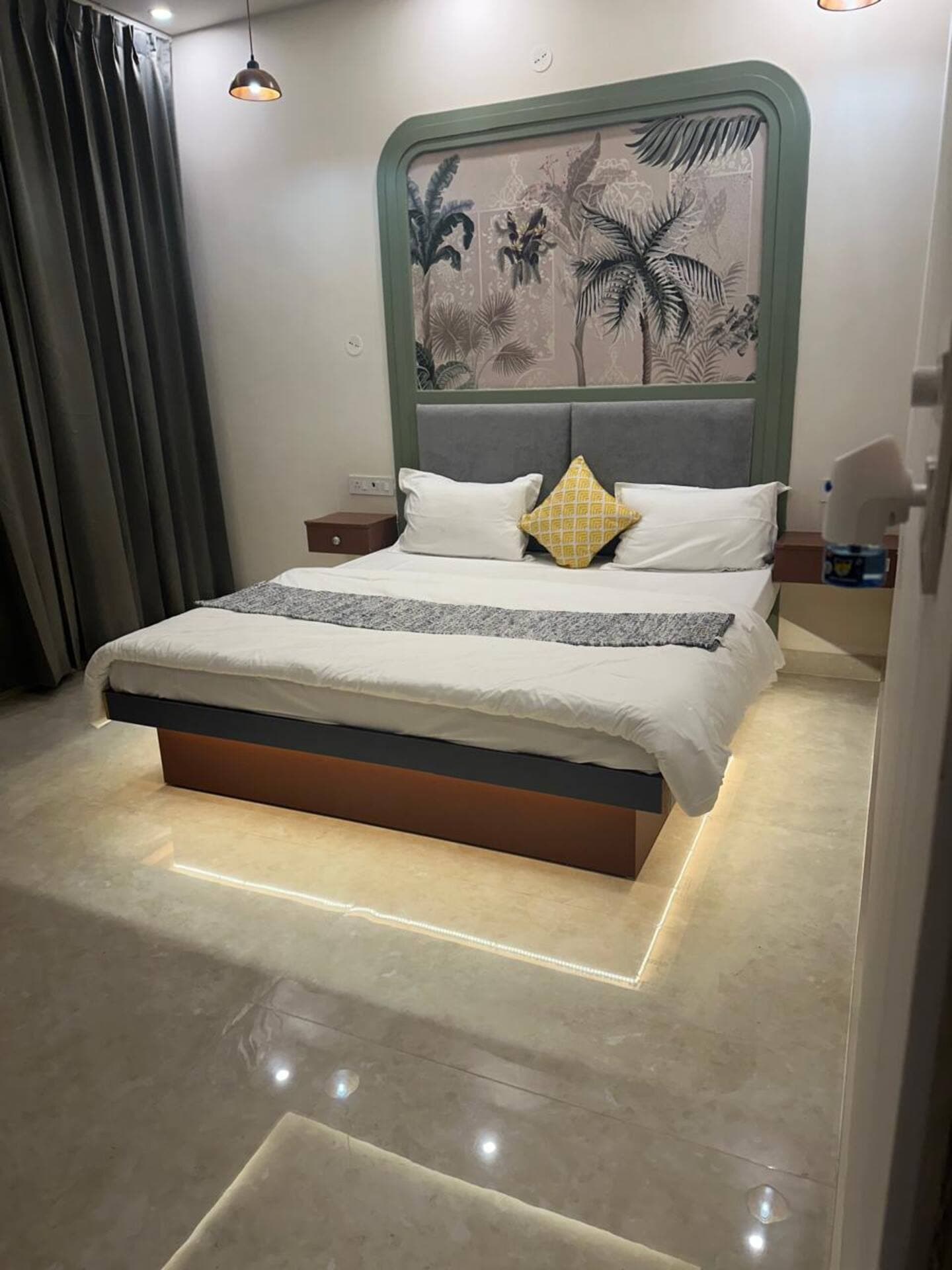 Boho by Starfish: Double bed with green arched palm print headboard and warm under-bed lighting