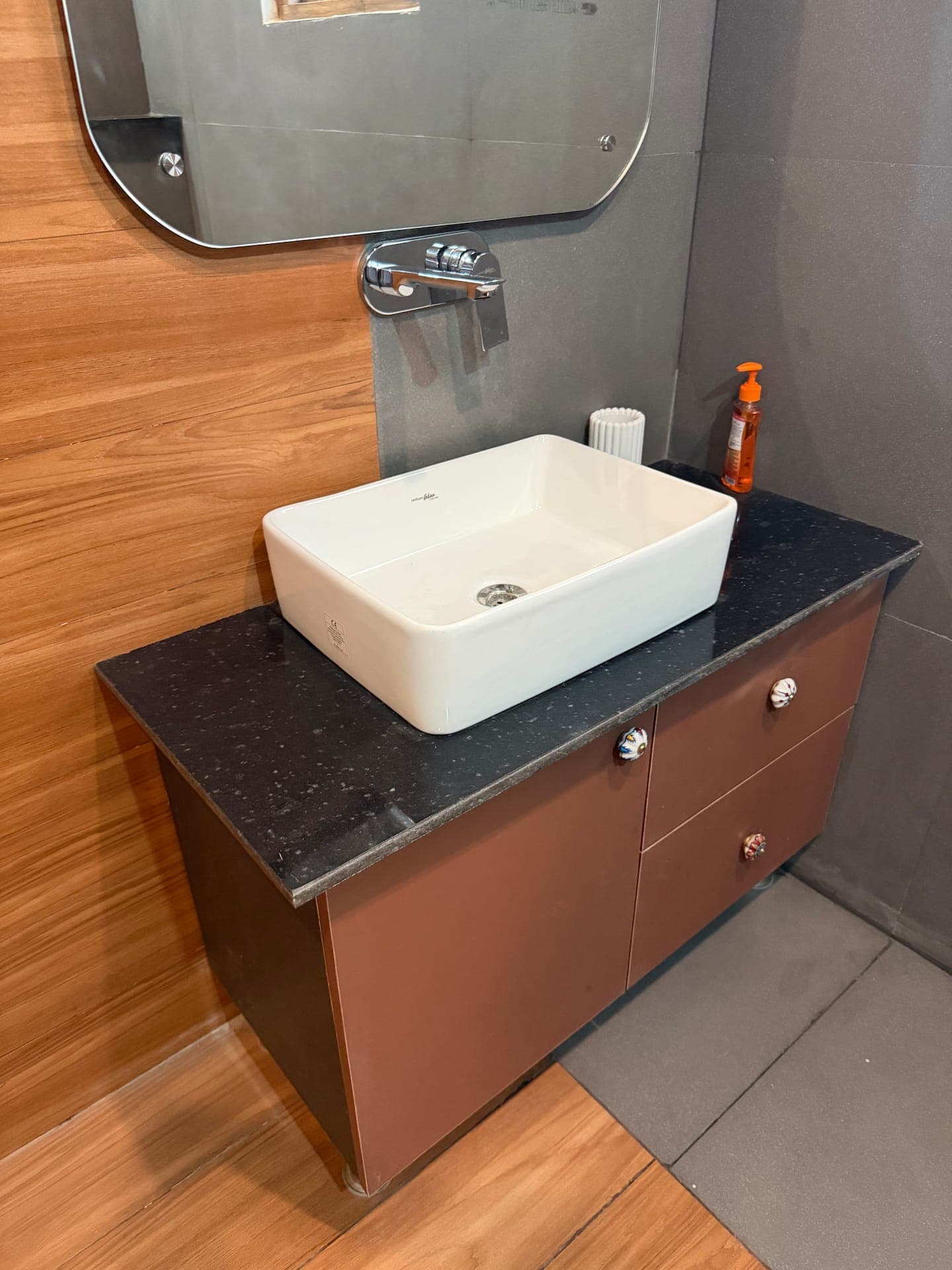 Boho by Starfish: White vessel basin on a dark granite vanity with drawers